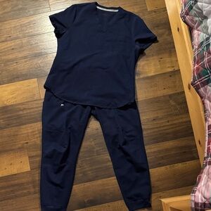 Fabletics Women’s Scrub Set. Vital 1-pocket scrub top & on-call scrub jogger.
